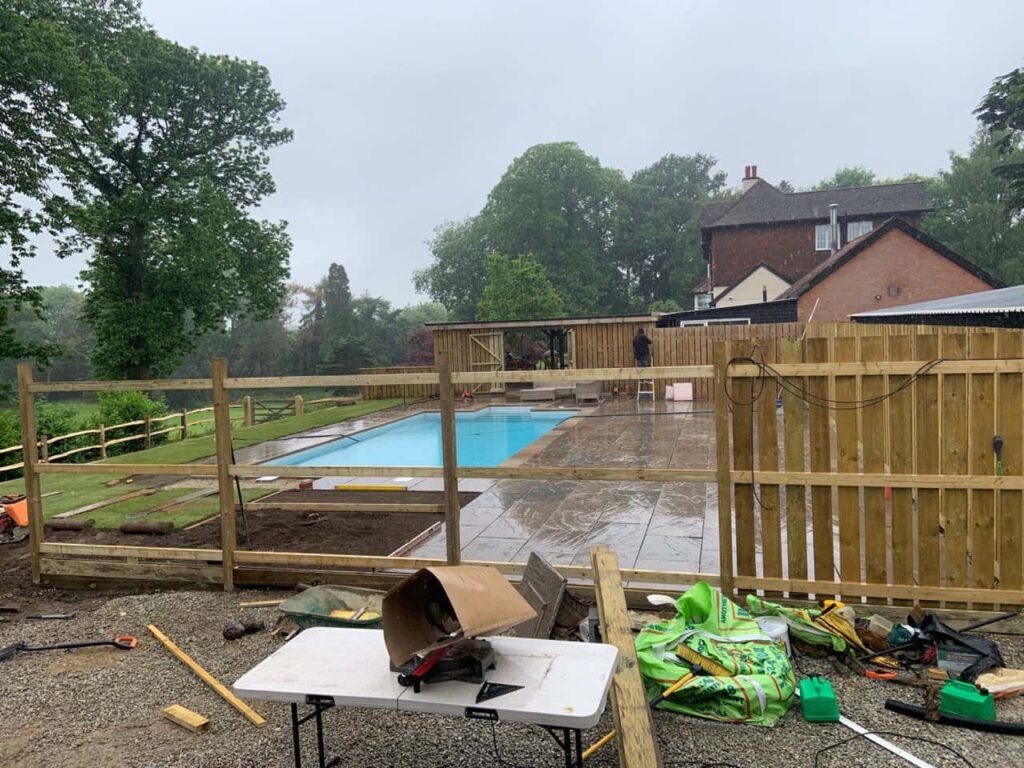 This is a photo of Bespoke custom fencing installed around a swimming pool by Fast Fix Fencing Oxted