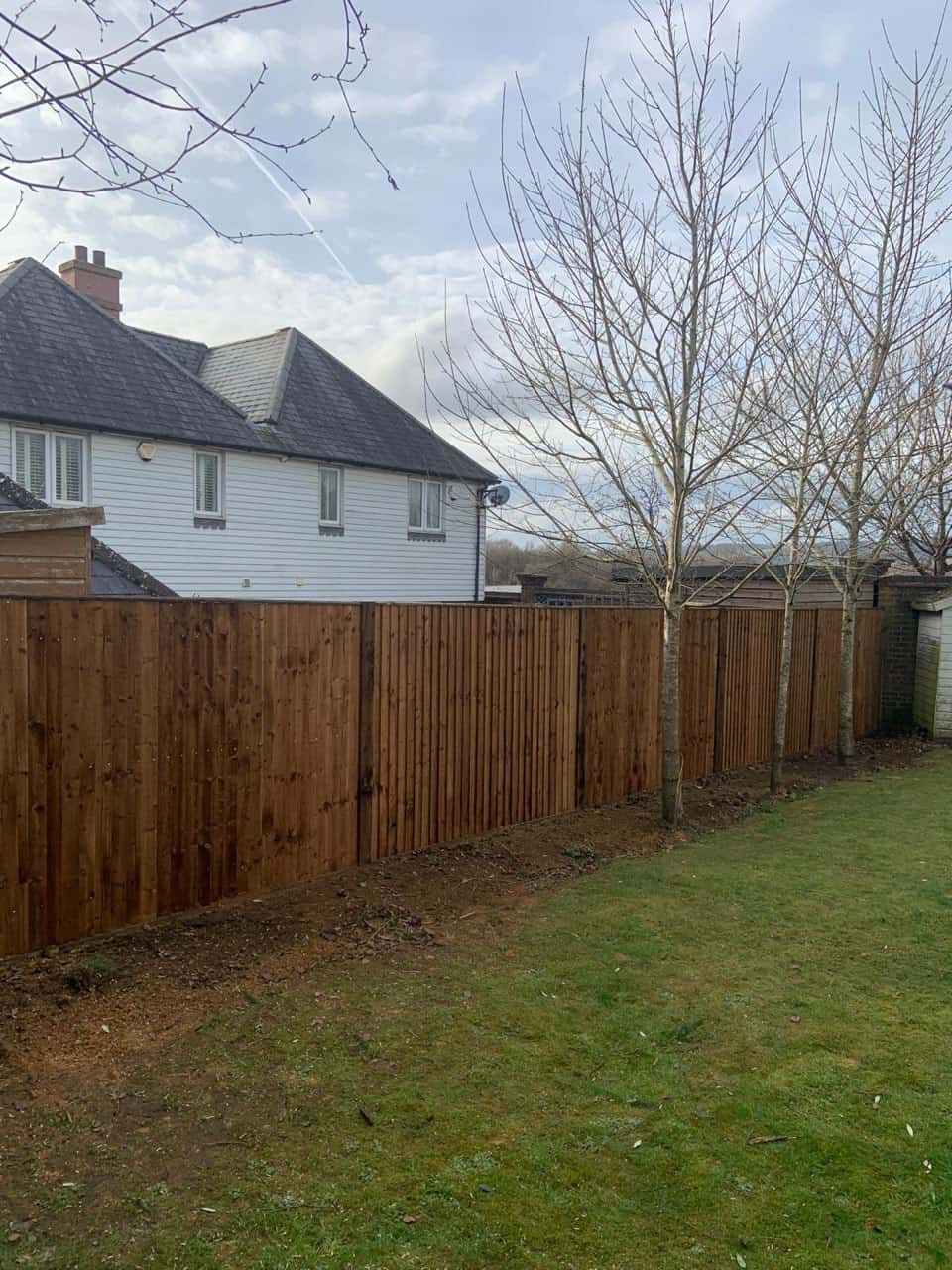 This is a photo of feather edge fencing installed in a residential properties garden by Fast Fix Fencing Oxted
