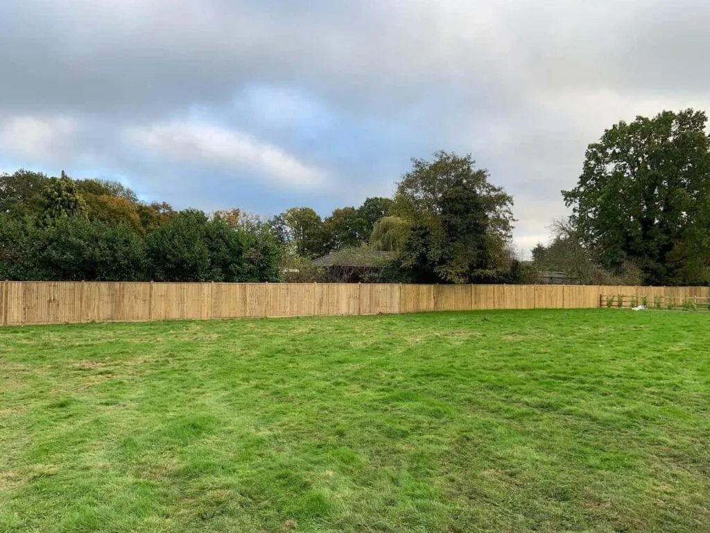 This is a photo of feather edge fencing installed around the edge of a field by Fast Fix Fencing Oxted