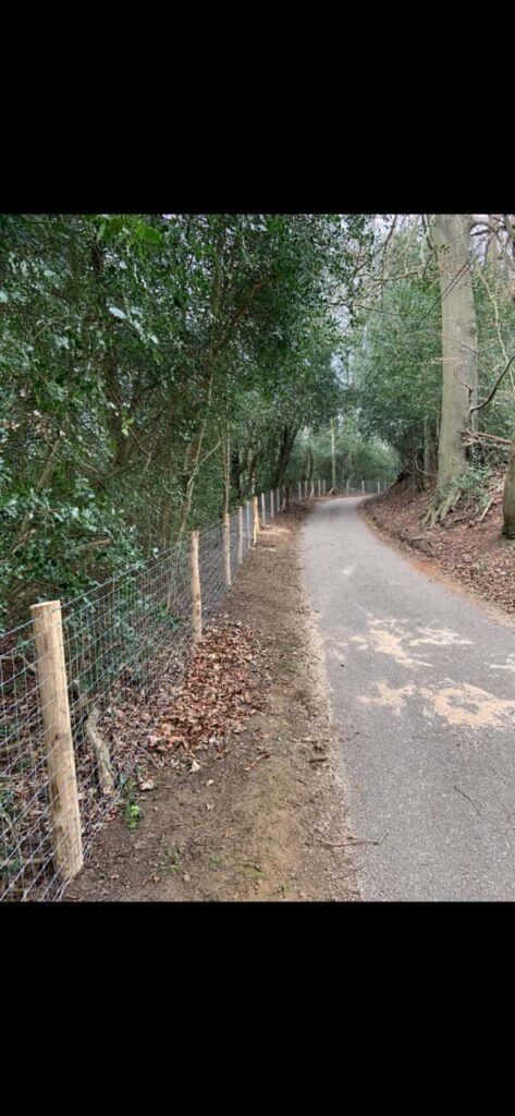 This is a photo of stock fencing installed along the side of a country road. By Fast Fix Fencing Oxted